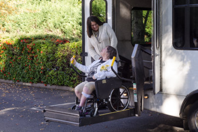 woman helping senior woman on wheelchair
